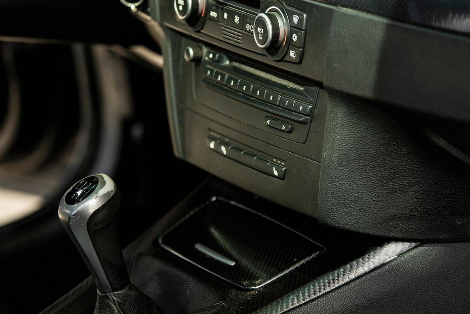 Interior view of a rental car dashboard, gear lever and centre console